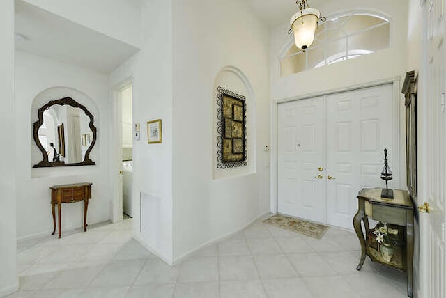 entrance foyer with a high ceiling and baseboards
