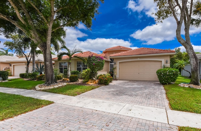 11654 Caracas Blvd, Boynton Beach, FL 33437 - view of front of home featuring a tile roof, a garage, stucco siding, a front yard, and decorative driveway