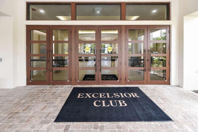 view of exterior entry with uncovered parking and french doors