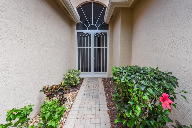 11654 Caracas Blvd, Boynton Beach, FL 33437 - doorway to property with stucco siding