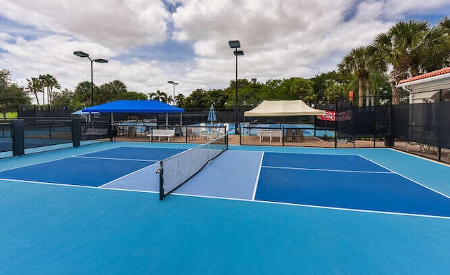 view of sport court featuring community basketball court and fence