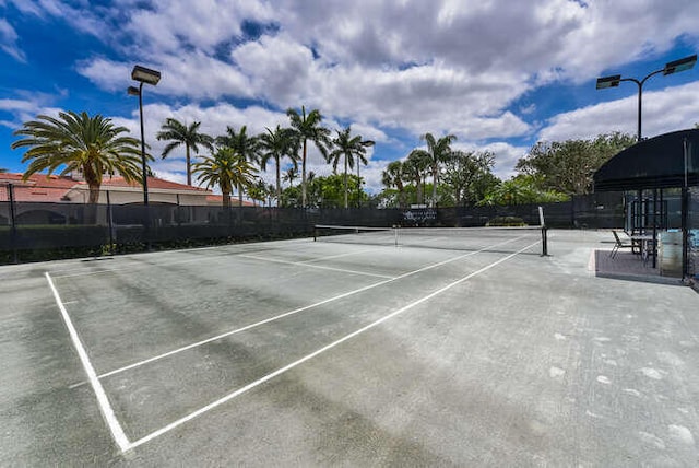 view of sport court featuring fence