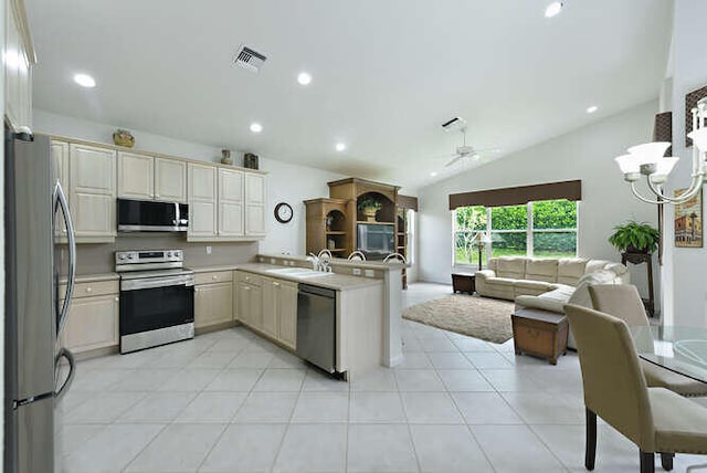kitchen featuring a peninsula, appliances with stainless steel finishes, light countertops, visible vents, and open floor plan