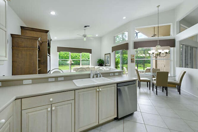 kitchen featuring a sink, dishwasher, vaulted ceiling, and ceiling fan with notable chandelier