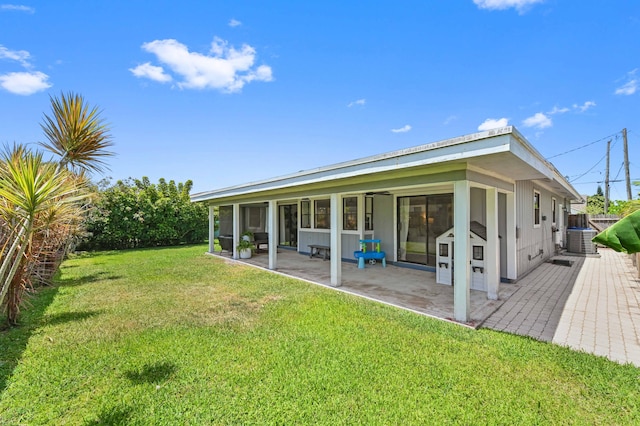 6214 Garrett St, Jupiter, FL 33458 - back of house with a patio, a lawn, and central air condition unit