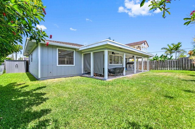 6214 Garrett St, Jupiter, FL 33458 - rear view of property featuring a lawn, ceiling fan, a patio area, and fence