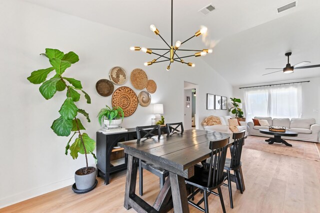 6214 Garrett St, Jupiter, FL 33458 - dining room with ceiling fan with notable chandelier, lofted ceiling, light wood-style flooring, and visible vents