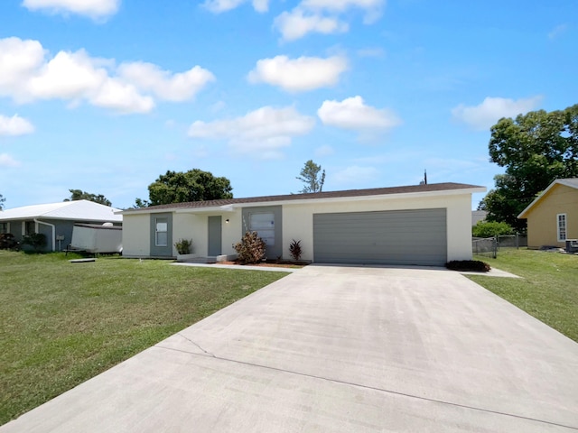 1541 SW Curry St, Port Saint Lucie, FL 34983 - view of front of house with concrete driveway, a garage, and stucco siding
