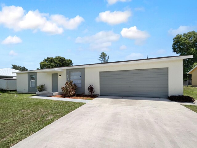 1541 SW Curry St, Port Saint Lucie, FL 34983 - view of front of house featuring stucco siding, concrete driveway, an attached garage, and a front yard