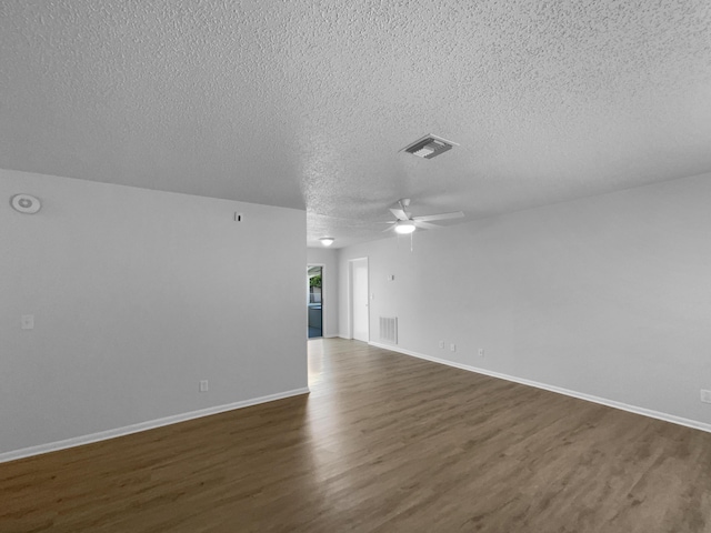 1541 SW Curry St, Port Saint Lucie, FL 34983 - unfurnished living room with a textured ceiling, dark wood finished floors, and ceiling fan