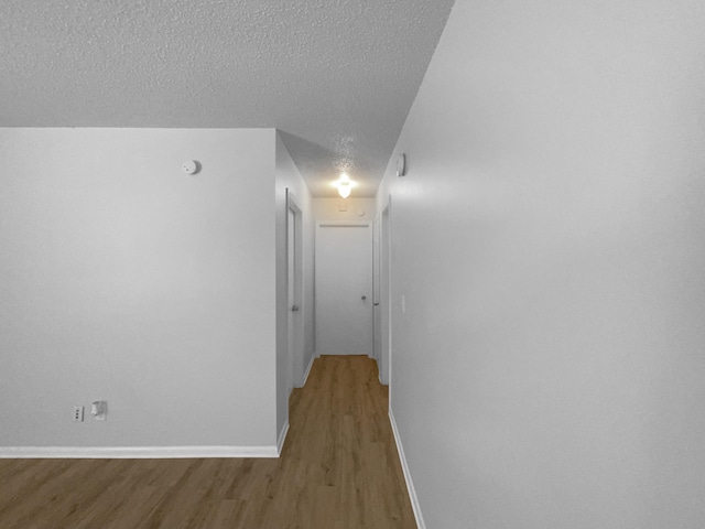 1541 SW Curry St, Port Saint Lucie, FL 34983 - hallway featuring a textured ceiling and wood finished floors