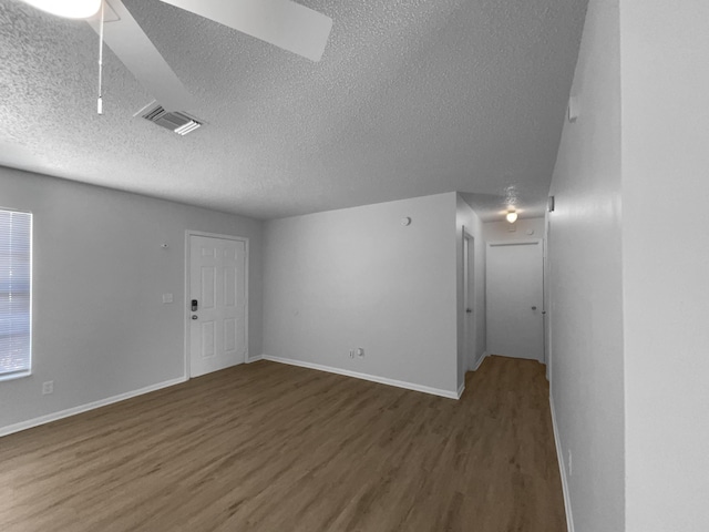 1541 SW Curry St, Port Saint Lucie, FL 34983 - spare room with wood finished floors and a textured ceiling