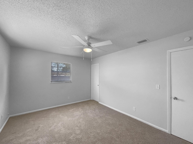 1541 SW Curry St, Port Saint Lucie, FL 34983 - spare room with ceiling fan, carpet floors, a smoke detector, and a textured ceiling