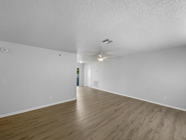 1541 SW Curry St, Port Saint Lucie, FL 34983 - unfurnished living room featuring dark wood-style flooring, a textured ceiling, and a ceiling fan