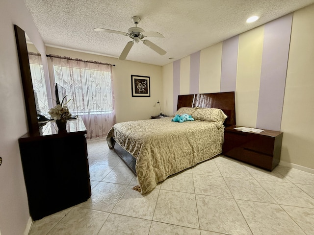 bedroom featuring a textured ceiling, baseboards, light tile patterned floors, and ceiling fan