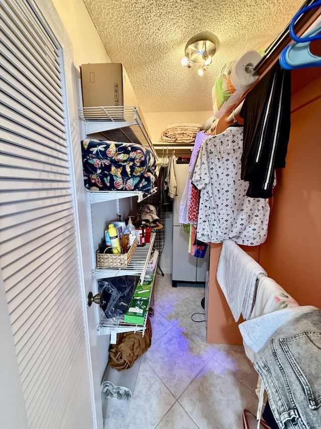 walk in closet with tile patterned flooring
