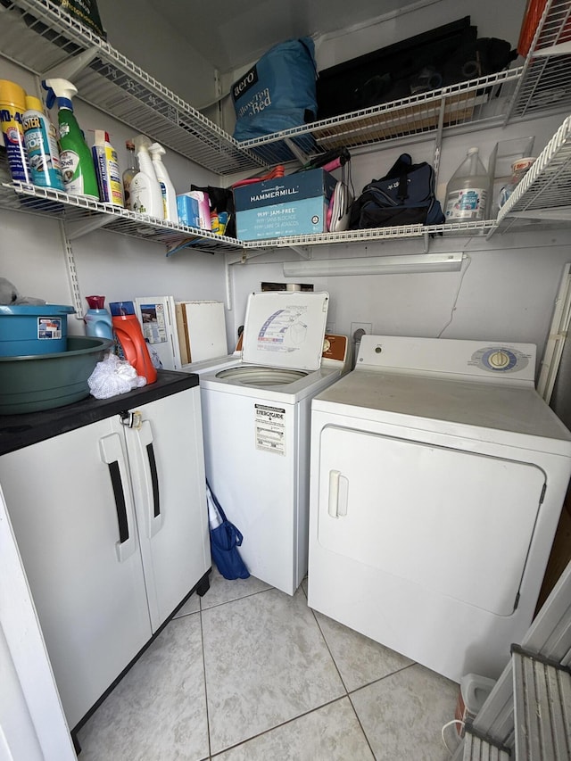 washroom featuring separate washer and dryer and light tile patterned floors