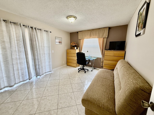 office with a textured ceiling and light tile patterned floors