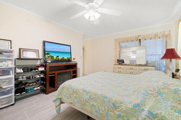 6531 SE Federal Hwy SE Unit Q108, Stuart, FL 34997 - bedroom featuring wood finished floors, crown molding, and ceiling fan
