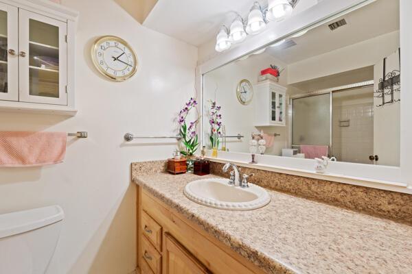 6531 SE Federal Hwy SE Unit Q108, Stuart, FL 34997 - bathroom with a stall shower, visible vents, vanity, and toilet