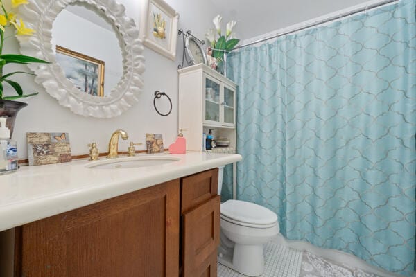 6531 SE Federal Hwy SE Unit Q108, Stuart, FL 34997 - bathroom featuring vanity, toilet, a shower with curtain, and tile patterned flooring