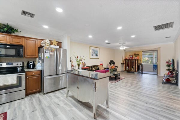 6531 SE Federal Hwy SE Unit Q108, Stuart, FL 34997 - kitchen featuring brown cabinetry, visible vents, recessed lighting, and appliances with stainless steel finishes