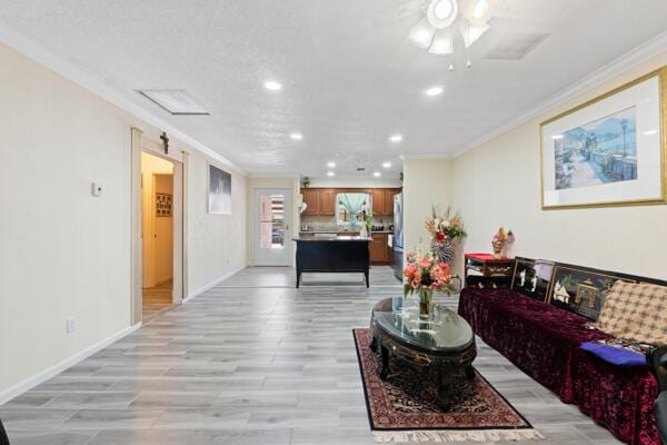 6531 SE Federal Hwy SE Unit Q108, Stuart, FL 34997 - living room featuring ceiling fan, ornamental molding, light wood-style flooring, and recessed lighting