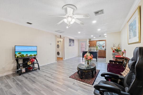 6531 SE Federal Hwy SE Unit Q108, Stuart, FL 34997 - living area featuring light wood-style flooring, visible vents, and ornamental molding