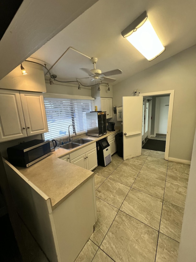 207 SW Bridgeport Dr, Port Saint Lucie, FL 34953 - kitchen with white cabinets, ceiling fan, a sink, light countertops, and stainless steel microwave