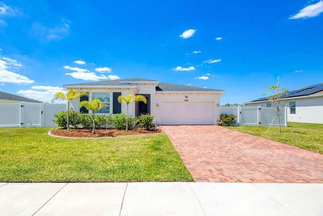 7568 NW Deysbrook Ln, Port Saint Lucie, FL 34987 - single story home with a front lawn, decorative driveway, an attached garage, and a gate