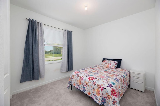 7568 NW Deysbrook Ln, Port Saint Lucie, FL 34987 - bedroom with light colored carpet and baseboards