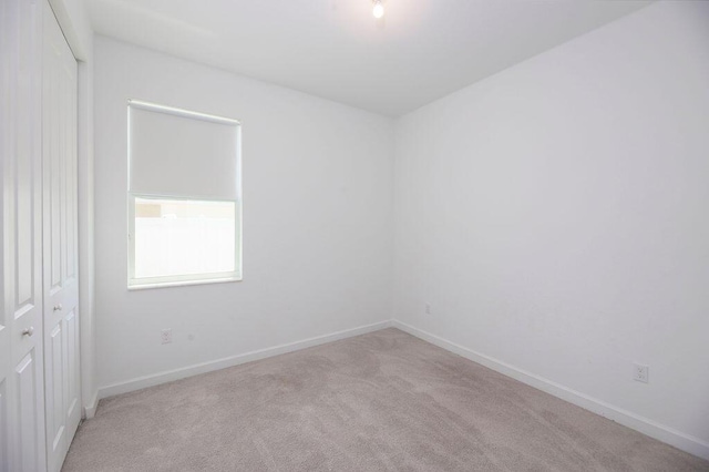 7568 NW Deysbrook Ln, Port Saint Lucie, FL 34987 - spare room featuring carpet and baseboards