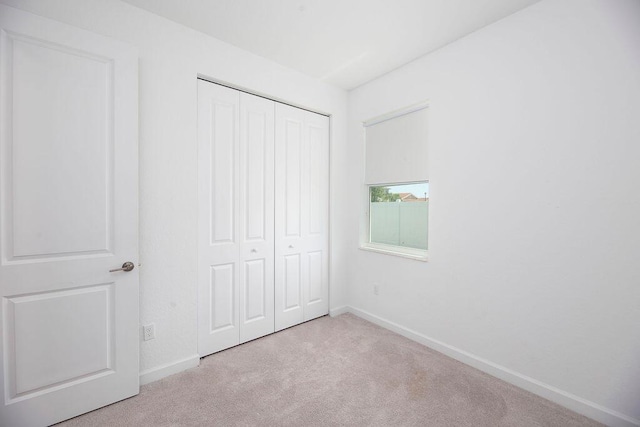 7568 NW Deysbrook Ln, Port Saint Lucie, FL 34987 - unfurnished bedroom with baseboards, carpet flooring, and a closet