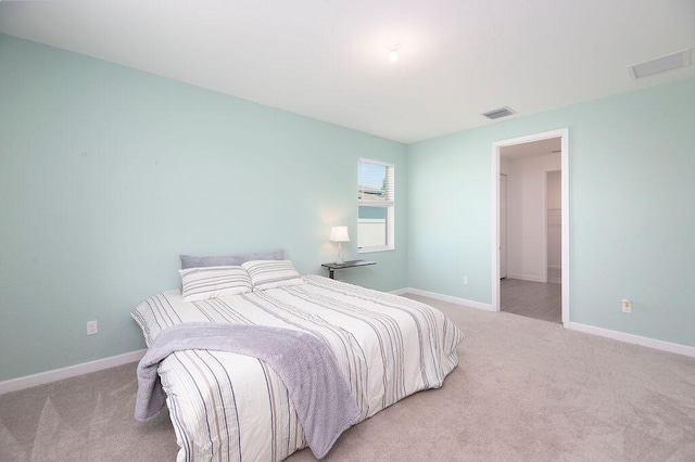7568 NW Deysbrook Ln, Port Saint Lucie, FL 34987 - bedroom with visible vents, light carpet, and baseboards