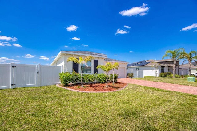 7568 NW Deysbrook Ln, Port Saint Lucie, FL 34987 - ranch-style home with a gate, fence, decorative driveway, a garage, and a front yard