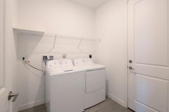7568 NW Deysbrook Ln, Port Saint Lucie, FL 34987 - washroom featuring baseboards, light wood-style floors, laundry area, and independent washer and dryer