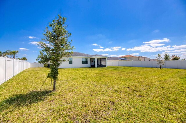 7568 NW Deysbrook Ln, Port Saint Lucie, FL 34987 - view of yard with a fenced backyard and a sunroom