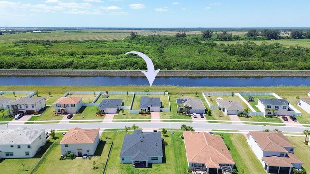 7568 NW Deysbrook Ln, Port Saint Lucie, FL 34987 - birds eye view of property featuring a water view and a residential view