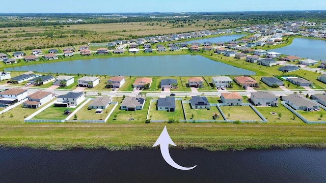 7568 NW Deysbrook Ln, Port Saint Lucie, FL 34987 - birds eye view of property with a residential view and a water view