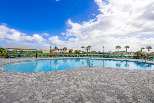 7568 NW Deysbrook Ln, Port Saint Lucie, FL 34987 - pool featuring a patio