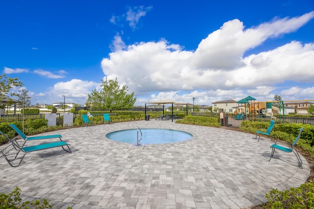 7568 NW Deysbrook Ln, Port Saint Lucie, FL 34987 - view of pool featuring a patio, playground community, a swimming pool, and fence