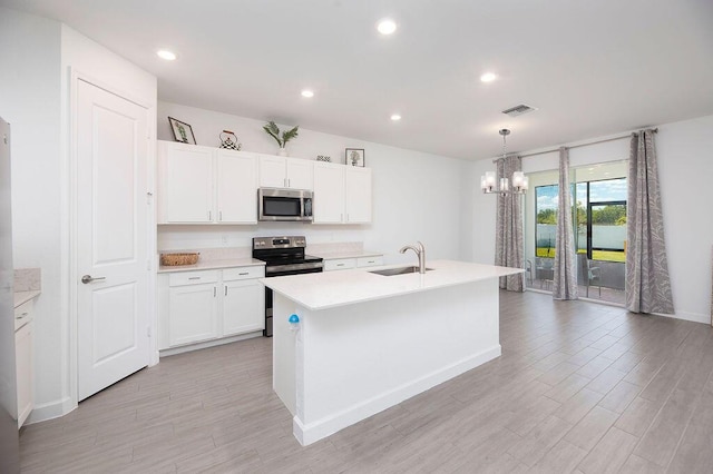 7568 NW Deysbrook Ln, Port Saint Lucie, FL 34987 - kitchen with a sink, a chandelier, stainless steel appliances, visible vents, and light countertops