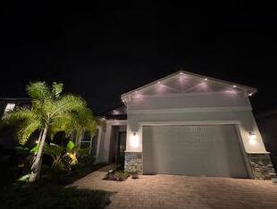 12408 Banner Ct, Palm Beach Gardens, FL 33412 - view of front of property with decorative driveway and an attached garage