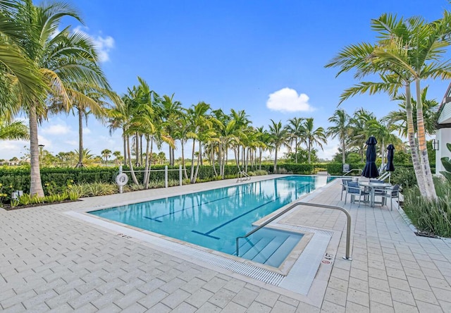 12408 Banner Ct, Palm Beach Gardens, FL 33412 - community pool featuring a patio