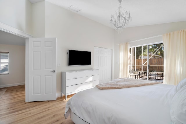 bedroom featuring light wood finished floors, baseboards, access to outside, high vaulted ceiling, and a notable chandelier