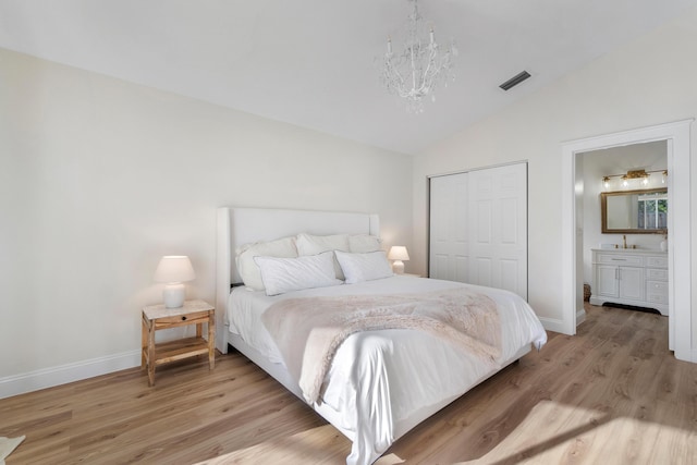 bedroom with visible vents, an inviting chandelier, light wood-style floors, lofted ceiling, and a closet