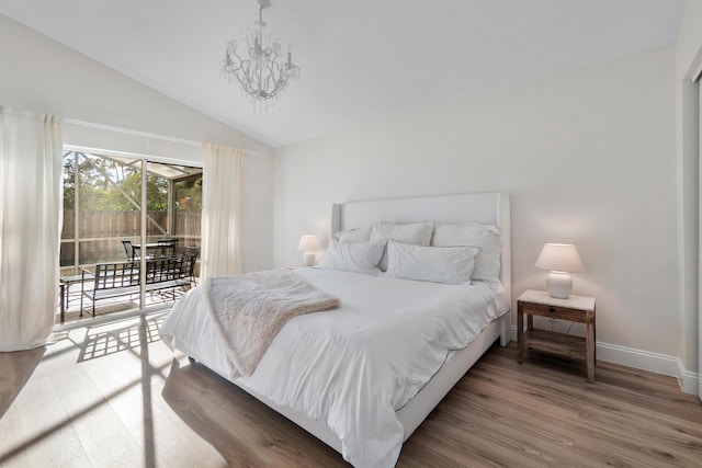 bedroom with lofted ceiling, wood finished floors, access to exterior, baseboards, and a notable chandelier