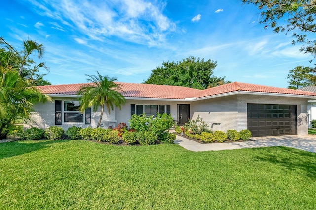 ranch-style home featuring brick siding, a tiled roof, an attached garage, and a front yard