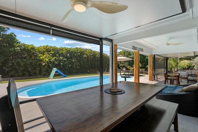 16629 74th Ave N, Palm Beach Gardens, FL 33418 - outdoor pool with a water slide, a ceiling fan, outdoor dining area, and a patio area