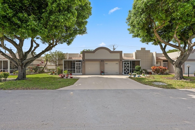 9305 Flynn Cir Unit 8, Boca Raton, FL 33496 - view of front of property with stucco siding, an attached garage, driveway, and a front lawn